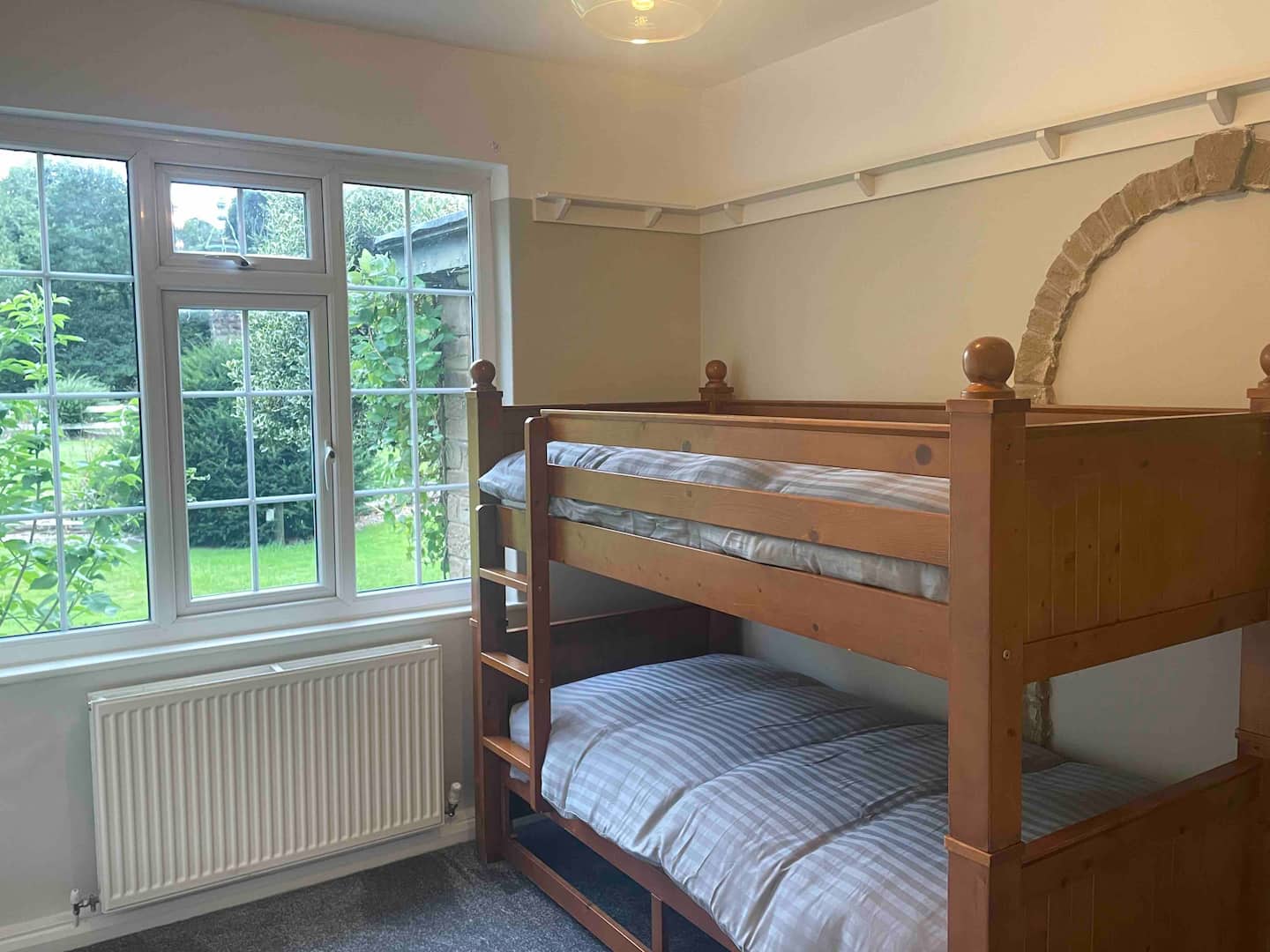 Kids bunk room with two sets of full bunk beds and colourful decor